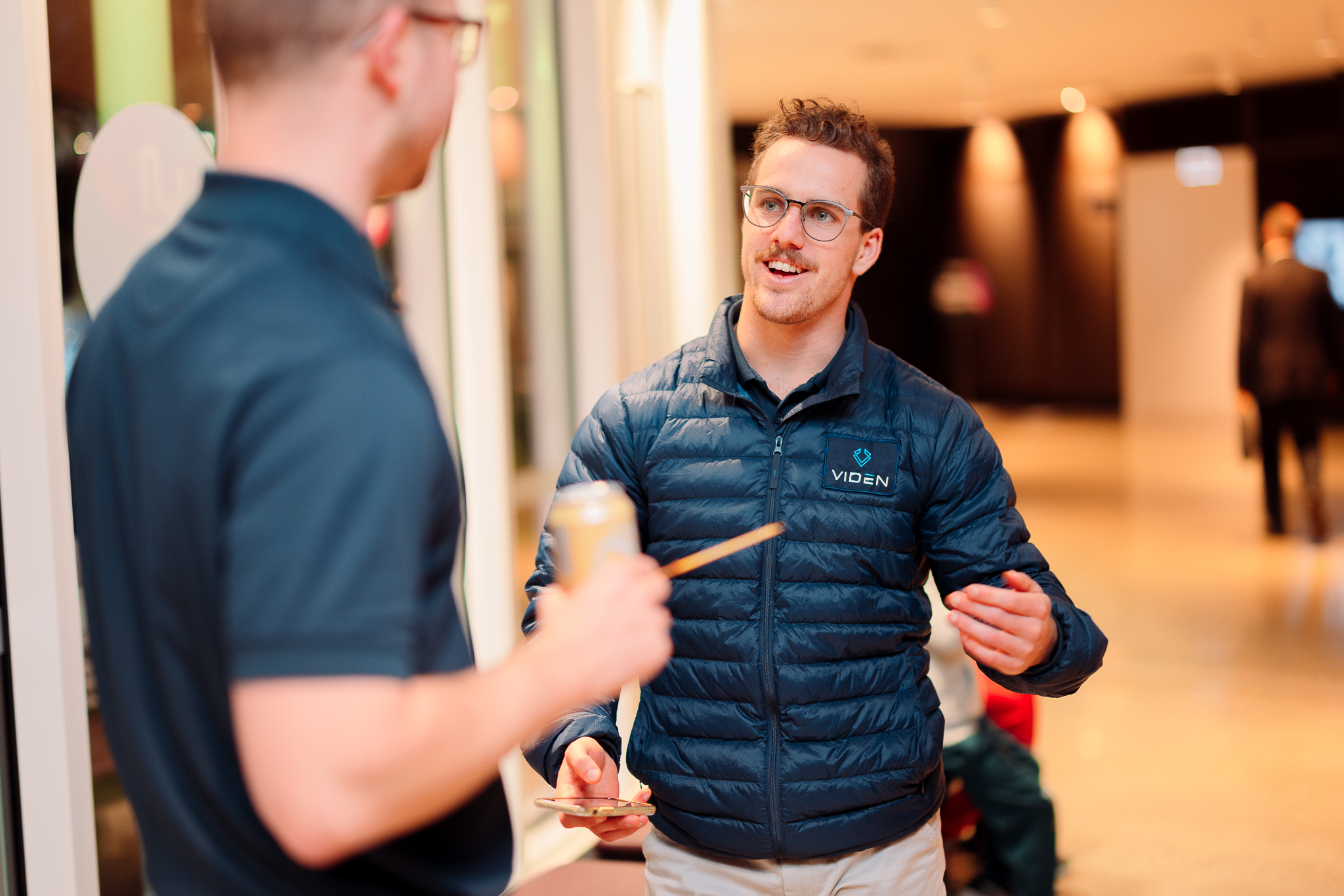 Two men talking at a networking event