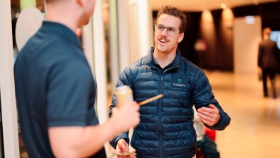 Two men talking at a networking event